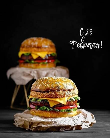 two cheeseburgers sitting on top of each other