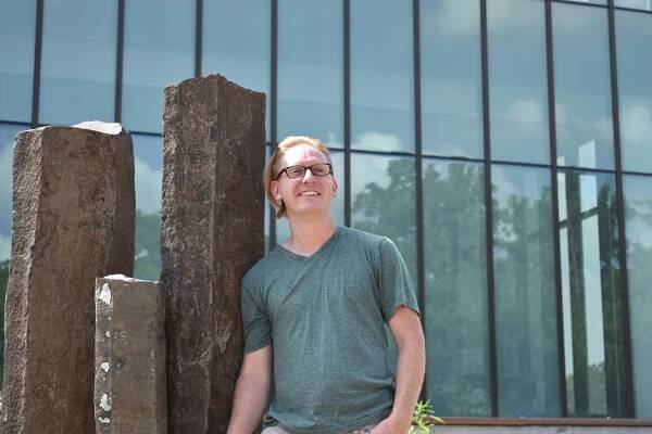 Jon-Erik Hem stands besides Discovery Hall