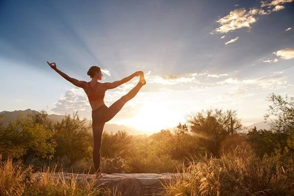 Person in yoga pose outdoors at Canyon Ranch at sunrise