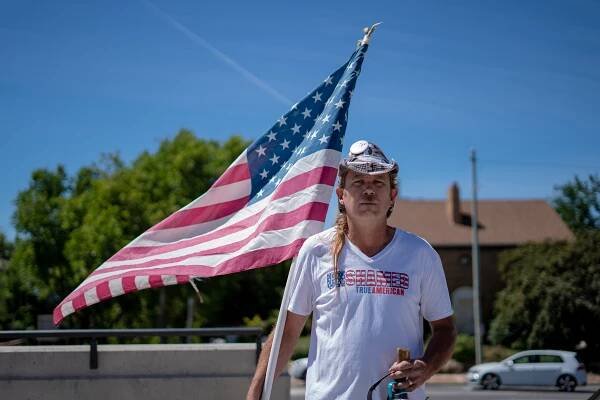 "Every race causes problems for America. There are laws to keep civil order. If we don’t have civil order, our social order breaks down. So it’s not just the illegal immigrants that cause a lot of problems," Martin Turner IV. An American flag in his hands and a Trump-Pence 2016 pin on his hat, Martin, stood quietly on the periphery of the protest at the Utah State Capitol Building. (Lenny Martinez Dominguez/News21)