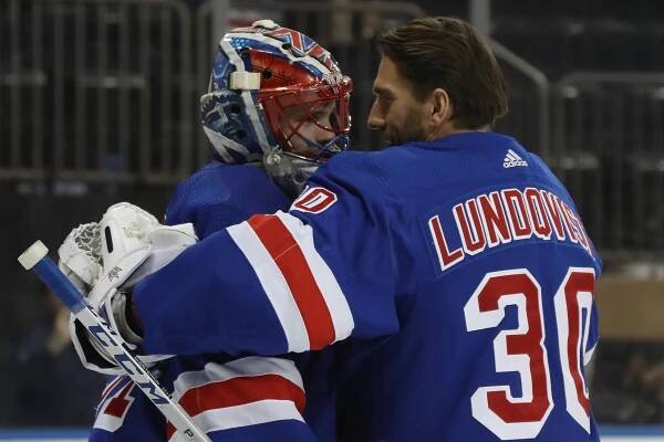 Henrik Lundqvist congratulates Igor Shesterkin after the young goalie recorded his first win with the Rangers on Jan. 7.