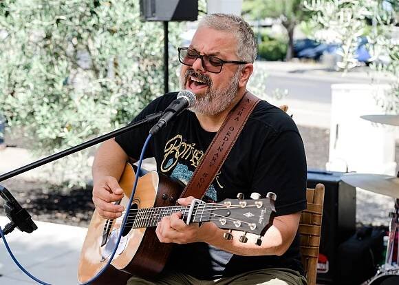 The singer from Ordinary Sons performs on guitar