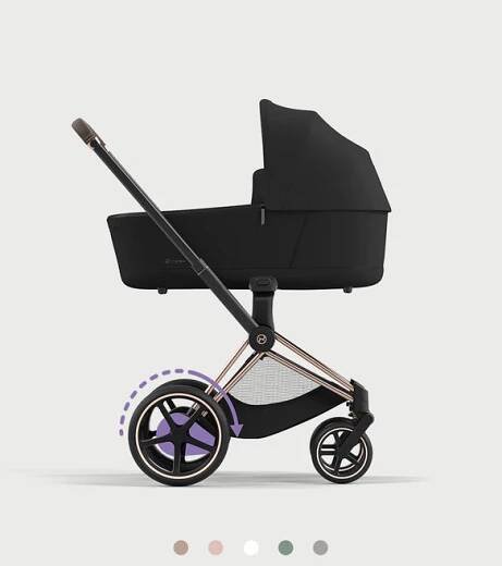 Black pram with rose gold frame, side view.