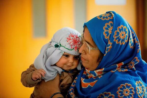 In Karachi, Pakistan, a girl is held by her mother in the waiting room of Jannat Gul Hospital in the suburb of Gujro