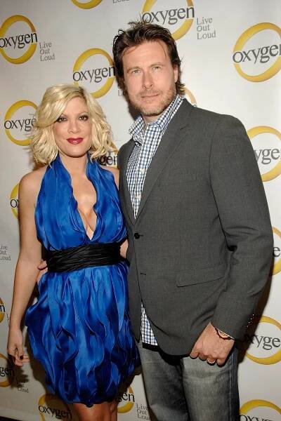 Tori Spelling and Dean McDermott posing together at an event.