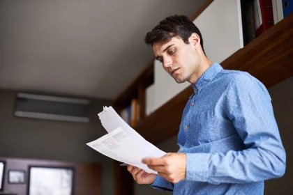 Man looking at stack of papers
