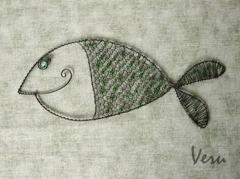 an embroidered fish with green eyes is shown