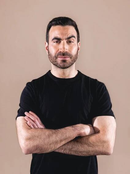 Man in black shirt poses for portrait