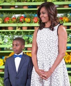 Michelle Obama wearing a Barbara Tfank dress with black piping and tiny bows on the shoulders