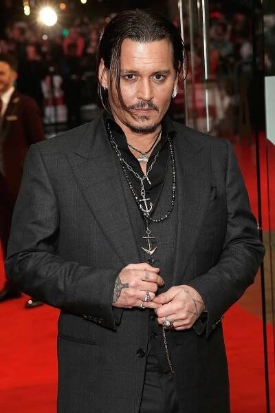 Image may contain Johnny Depp Fashion Premiere Human Person Red Carpet Red Carpet Premiere Coat Clothing and Suit