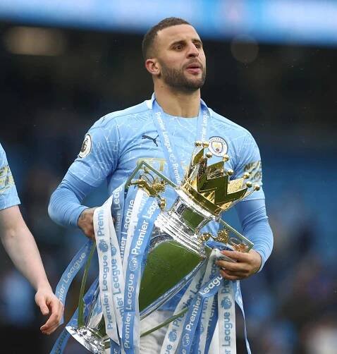 Kyle Walker of Manchester City lifts the Premier League trophy.