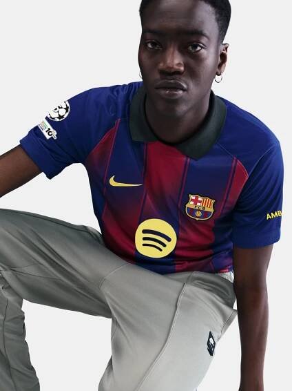 "Male model wearing the official FC Barcelona 2025/26 home jersey yellow Nike and Spotify logos, and UEFA Champions League patch on the sleeve."