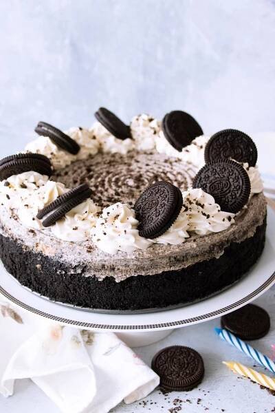 Rich and creamy Oreo cheesecake, set on a cake stand, perfect for celebrating