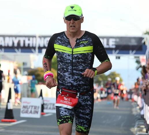 Male athlete running on Ironman NZ course