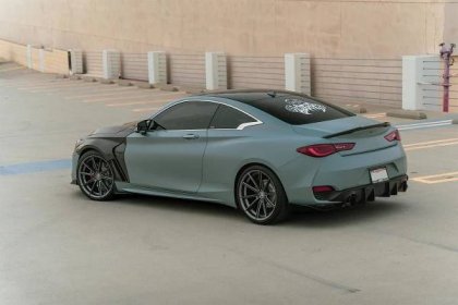 A modified Infiniti Q60 with carbon fiber front fenders and Curva Concepts C46 aftermarket wheels