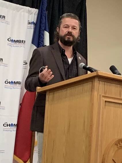 Ian MacLean speaking at a podium at a Chamber of Commerce event