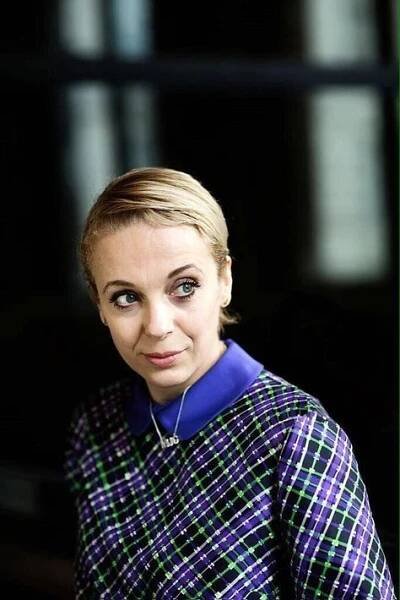 a woman wearing a purple and green coat