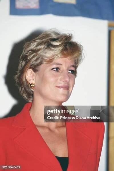 British royal Diana, Princess of Wales , wearing a red two-piece suit by Catherine Walker, during a visit to London Lighthouse, a centre for people...