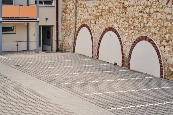 a brick walkway next to a building with arches at Apartmán MIKU-LOVE in Mikulov