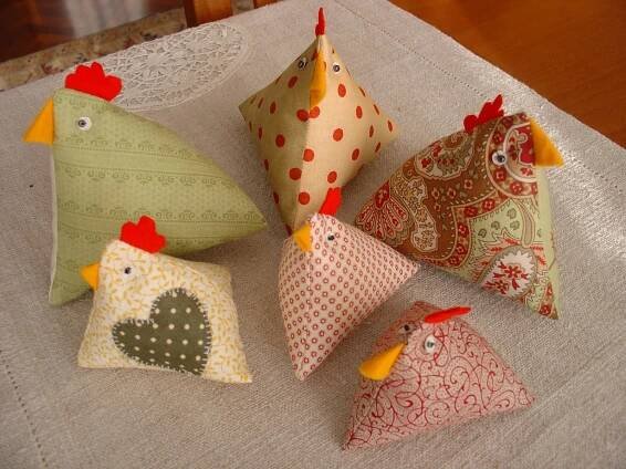 four pillows with different designs on them sitting on a table