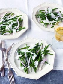 haricots verts with green goddess dressing on white octagonal plates with silverware