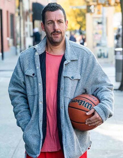 Adam Sandler carries a basketball in New York