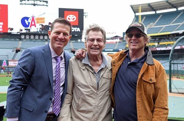 Actor Ryan O'Neal (C) poses with his son Patrick O'Neal (L), Los Angeles Angels television play-by-play announcer, and actor director Hart Bochner prior to the start of a baseball game between Oakland Athletics and Los Angeles Angels at Angel Stadium of Anaheim on May 21, 2022 in Anaheim, California. 