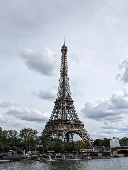 Free Stunning view of the Eiffel Tower against a sky adorned with clouds, showcasing iconic Parisian architecture. Stock Photo