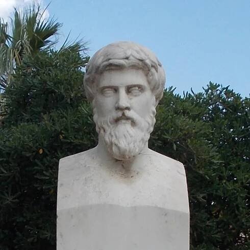 A white stone bust of a bearded man.
