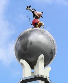 A bird in Mickey's hand on top of the Crossroads of the World statue at Disney's MGM Studios.