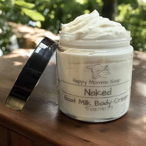 May include: A glass jar with a black lid filled with a white goat milk body cream. The jar has a label that reads "Happy Momma Soap" and "Naked Goat Milk Body Cream 5 oz/141.73".
