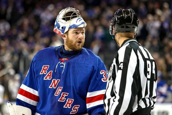 Rangers goalie Jonathan Quick (32) talks to linesman Bryan Pancich