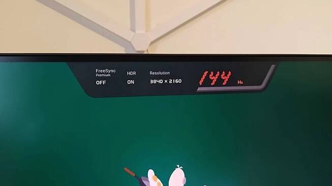BenQ Mobiuz EX321UX with OSD banner at top of screen displaying refresh rate and resolution