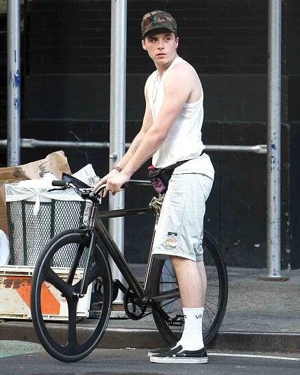 Brooklyn Beckham Shows off His Guns in a Sleeveless Top While Riding Through Soho