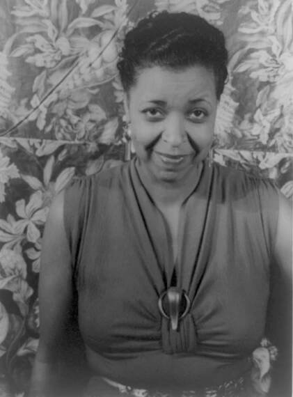 A black and white headshot of Ethel Waters against a floral background.