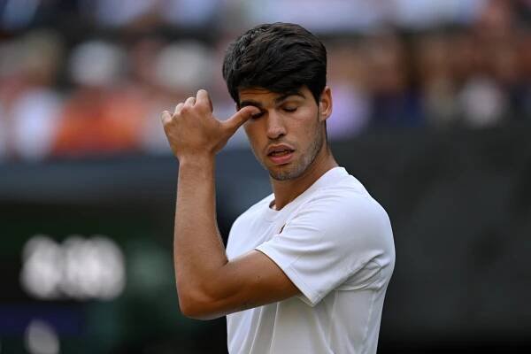 Carlos Alcaraz of Spain reacting during a tennis match.
