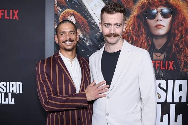 Charlie Barnett and Drew Binder on a red carpet.