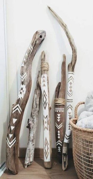 driftwood art displayed on wooden floor next to basket