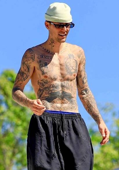 Justin Bieber shows off his ripped body as he hangs out with friends on the rooftop of a building in L.A.