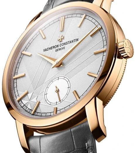 The Vacheron Constantin Traditionnelle Manual-winding is a limited edition 18K pink gold wristwatch with a silver geometric-patterned dial, gold hour markers, and a black leather strap.