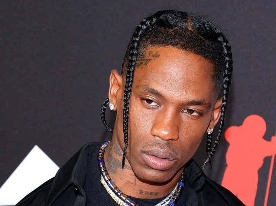 Travis Scott on stage performing for a sold out crowd