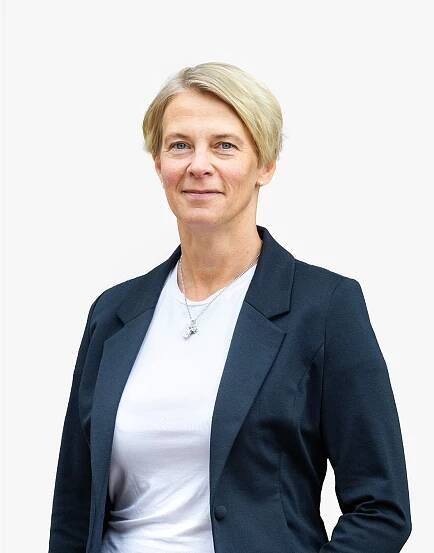 A woman wearing a blue jacket and a white shirt