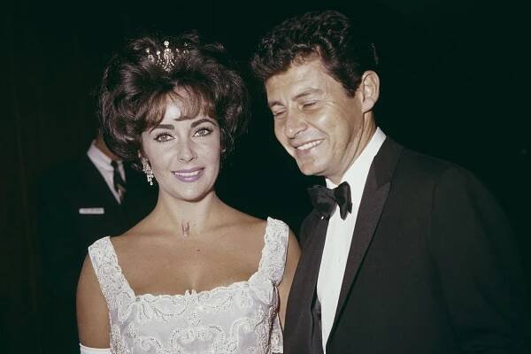 American singer and actor Eddie Fisher and British actor Elizabeth Taylor attend the Academy Awards