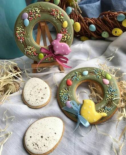 some cookies are sitting on a table with easter decorations