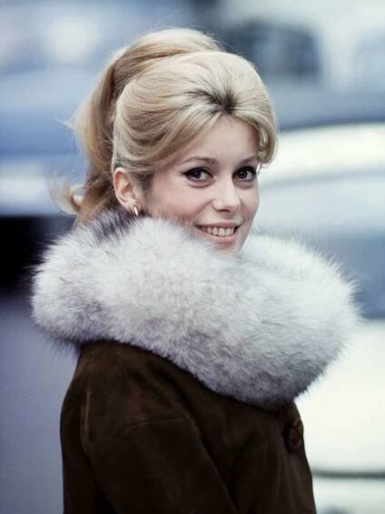 Catherine Deneuve with her iconic voluminous center, brushed-back part in 1963