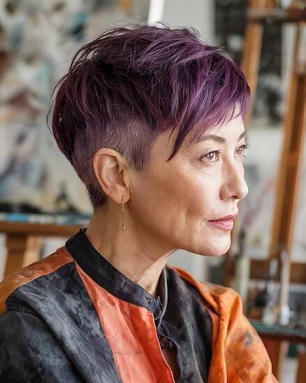 Modern pixie haircut with purple layers and undercut sides for bold older women with straight fine hair