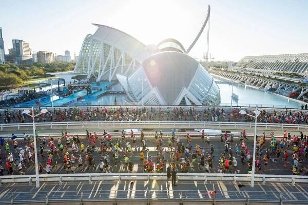Runners passing stunning architecture during the Valencia Marathon 2024