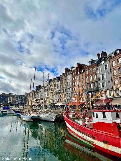 Harbour of Honfleur with ships and sail boats. Shots and houses in the backdrop