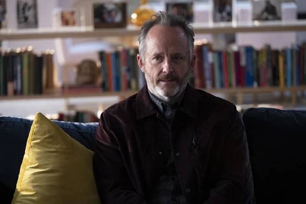 Photo of John Benjamin Hickey sitting on a couch in a scene from the season finale of "In Treatment."