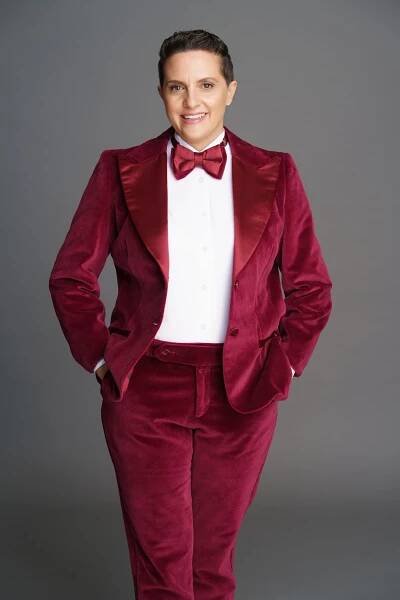 Nathalie Virem wearing burgundy velvet tuxedo.